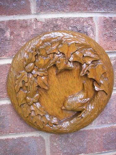 A small plaque carved to cover a vent from the utility room because birds were trying to nest in it. If they had come further in, they would have ended up in the washing machine!